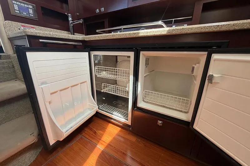 Slide: The Image of Open refrigerator and freezer in 2008 Sea Ray 36 Sedan Bridge yacht kitchen. - 20