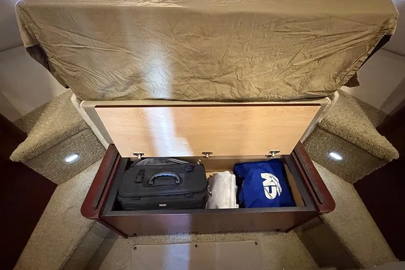Slide: The Image of Under-seat storage on 2008 Sea Ray 36 Sedan Bridge with luggage and clothing. - 23
