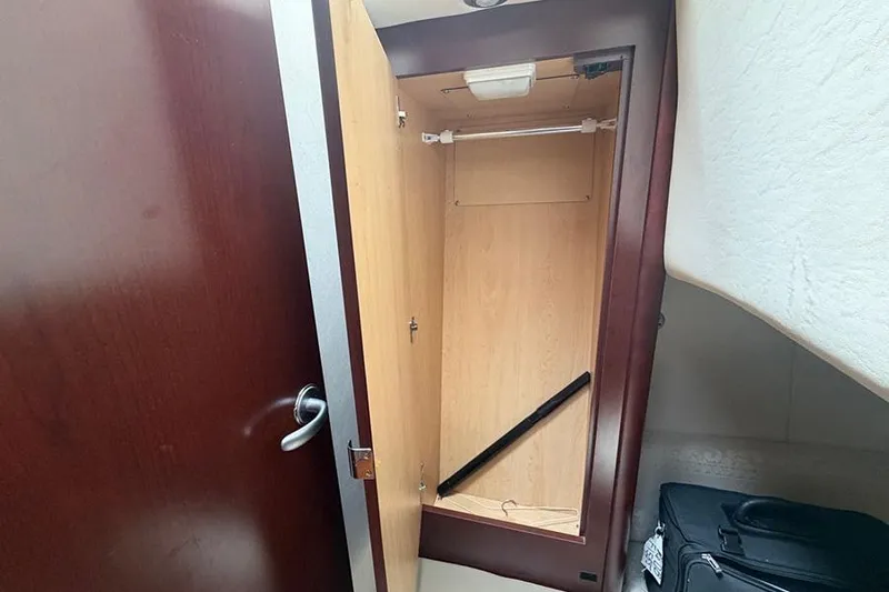 Slide: The Image of Open wooden closet inside 2008 Sea Ray 36 Sedan Bridge yacht cabin. - 27