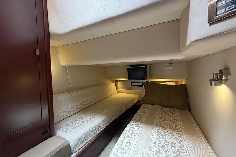 Slide: The Image of 2008 Sea Ray 36 Sedan Bridge cabin with twin beds and TV. - 28