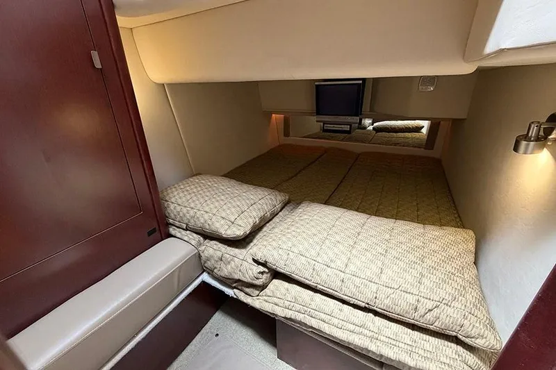 Slide: The Image of Interior cabin of 2008 Sea Ray 36 Sedan Bridge with cozy bedding and TV. - 29
