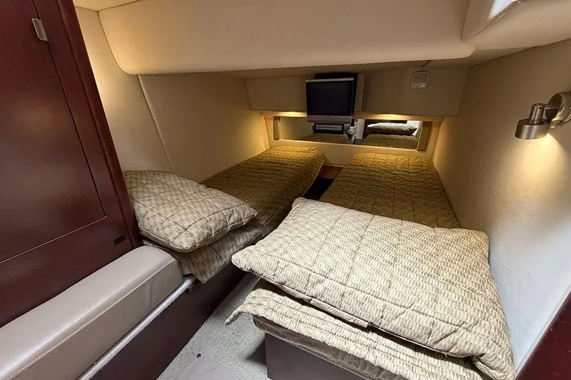 Slide: The Image of 2008 Sea Ray 36 Sedan Bridge cabin with twin beds and TV, cozy interior. - 32