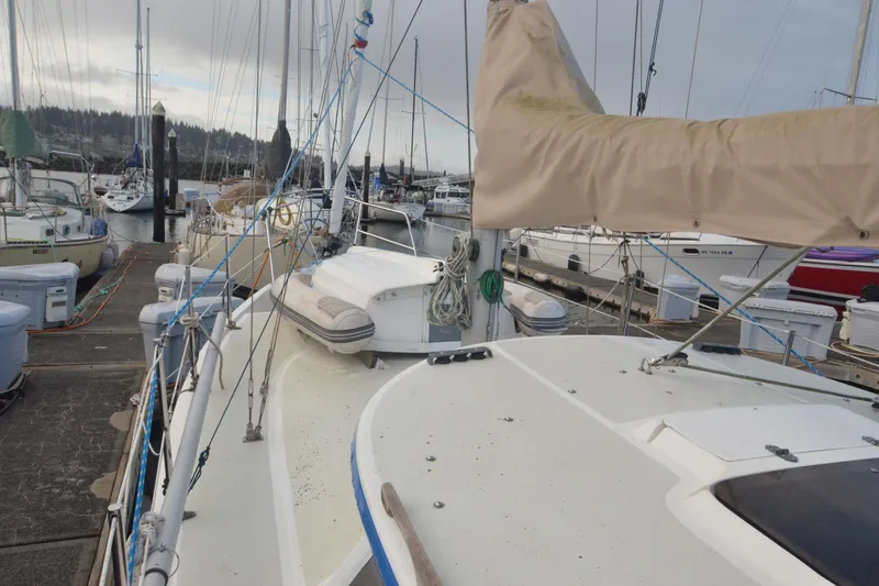 Slide: The Image of 1988 Gulf Pilot House sailboat docked at a marina, surrounded by other boats. - 1