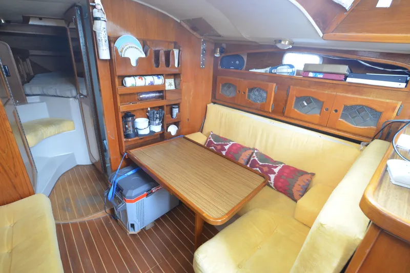 Slide: The Image of Cozy interior of 1988 Gulf Pilot House boat with wooden furnishings and seating area. - 10