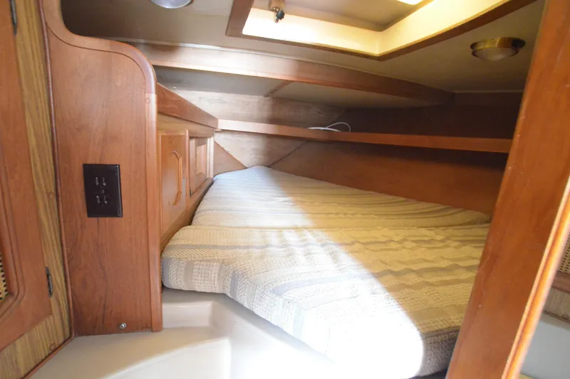 Slide: The Image of Cozy cabin interior of 1988 Gulf Pilot House with wooden finish and comfortable bedding. - 13