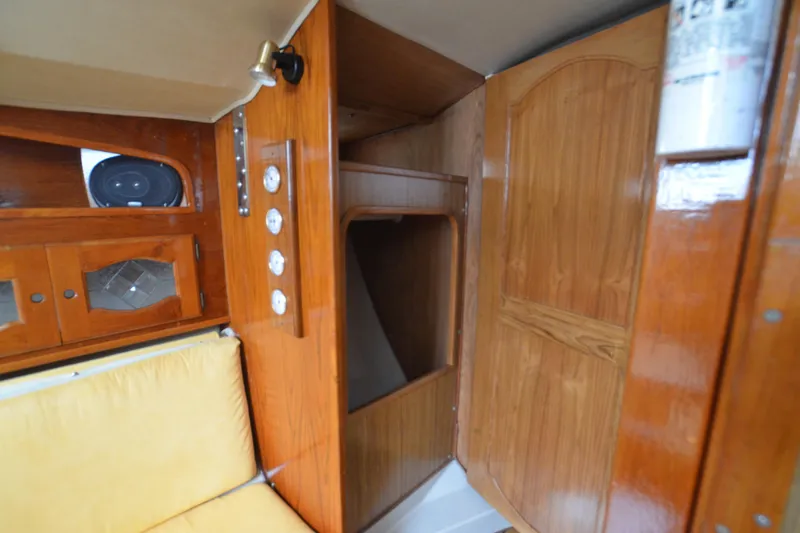 Slide: The Image of 1988 Gulf Pilot House interior with wooden cabinetry and yellow seating. - 14