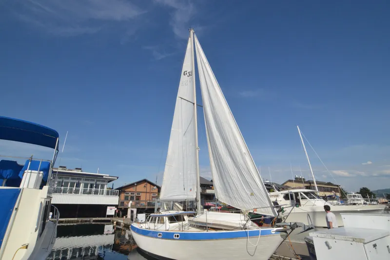Slide: The Image of 1988 Gulf Pilot House sailboat docked at marina under clear blue sky. - 16
