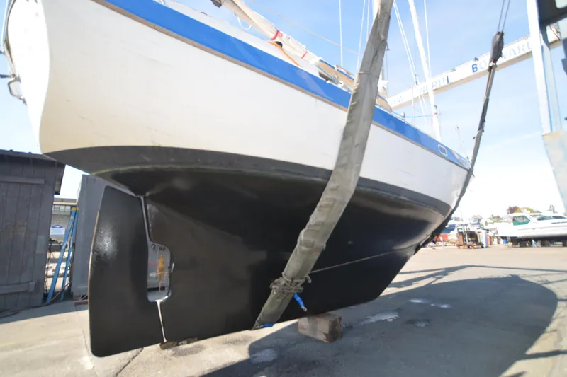 Slide: The Image of 1988 Gulf Pilot House sailboat in dry dock, showing hull and keel. - 19