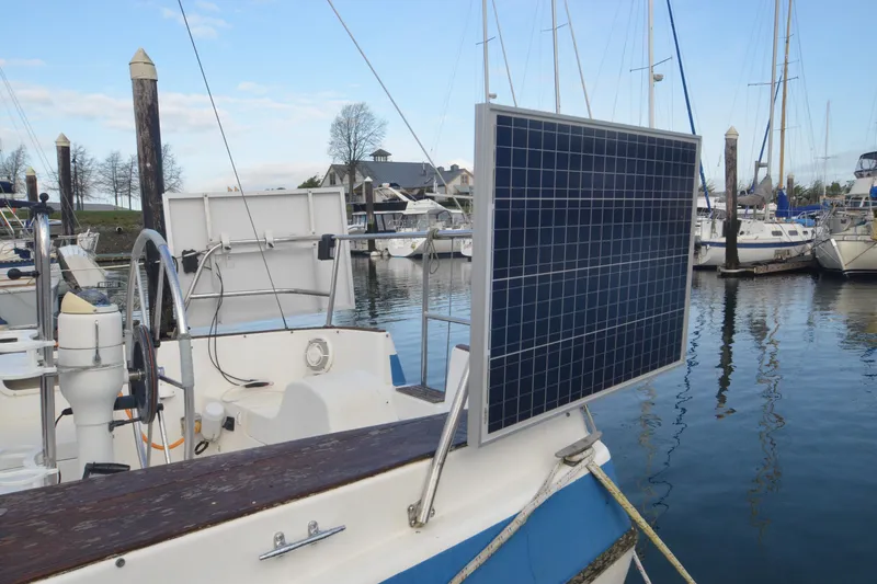 Slide: The Image of 1988 Gulf Pilot House boat with solar panel docked at marina. - 2