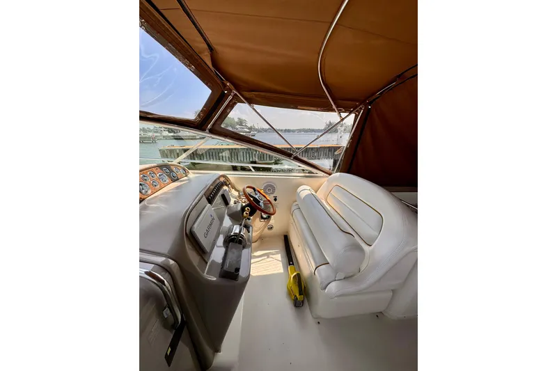 Slide: The Image of Interior view of 2000 Sea Ray 290 Amberjack boat cockpit with steering wheel and controls. - 11