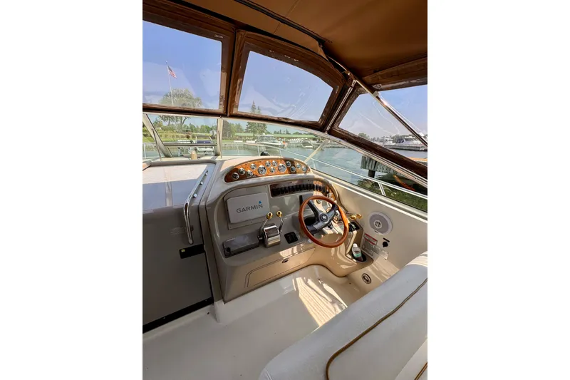 Slide: The Image of Cockpit of 2000 Sea Ray 290 Amberjack with Garmin navigation system and wooden steering wheel. - 12