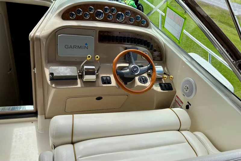 Slide: The Image of Cockpit of 2000 Sea Ray 290 Amberjack with Garmin navigation and wood-accented steering wheel. - 13