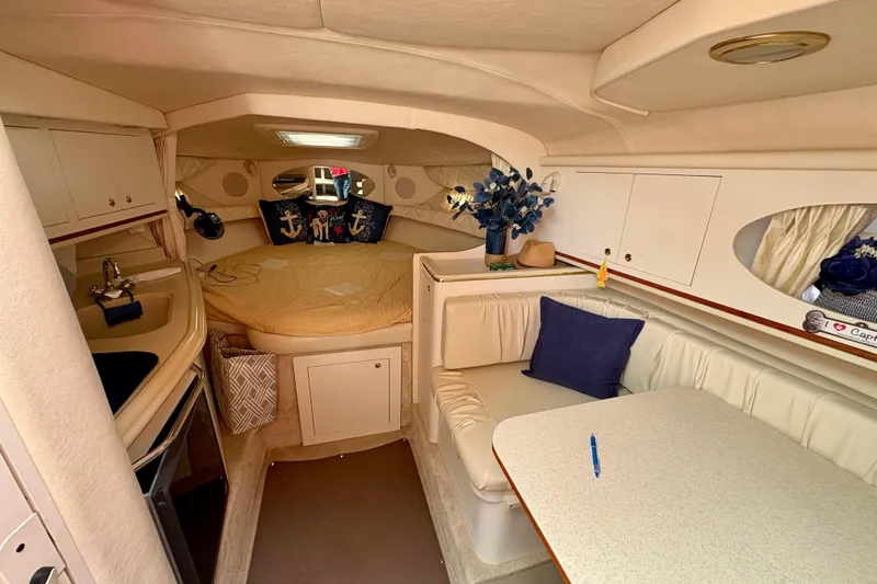 Slide: The Image of Interior of 2000 Sea Ray 290 Amberjack boat with cozy seating and sleeping area. - 15