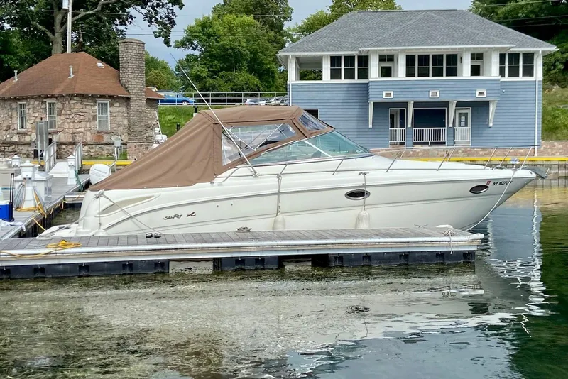Slide: The Image of 2000 Sea Ray 290 Amberjack docked near waterfront buildings. - 2
