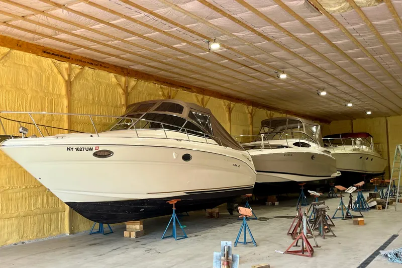 Slide: The Image of 2000 Sea Ray 290 Amberjack boats stored indoors on stands. - 3