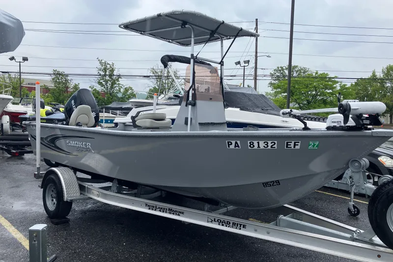 The Image of 2024 Smoker Craft Freedom 180 CC boat on trailer, parked outdoors. - 1