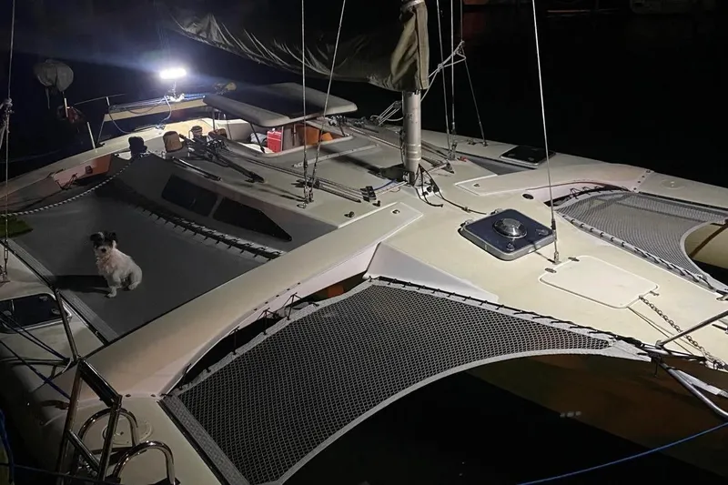 Slide: The Image of Sailboat Corsair F27 (1991) at night with a dog on deck. - 10