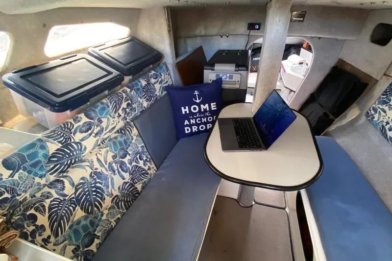 Slide: The Image of Cozy interior of 1991 Corsair F27 sailboat with laptop and nautical decor. - 12