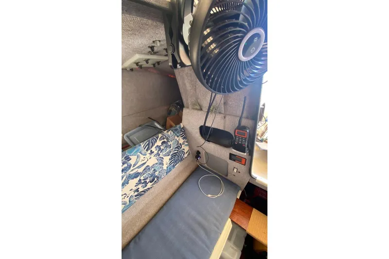 Slide: The Image of Interior of a 1991 Corsair F27 sailboat with fan, radio, and floral cushion. - 15
