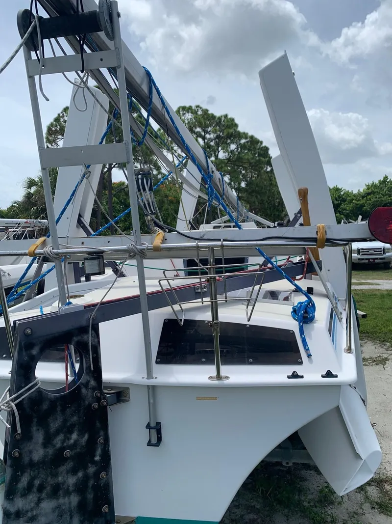 Slide: The Image of 1991 Corsair F27 trimaran on a trailer outdoors. - 4