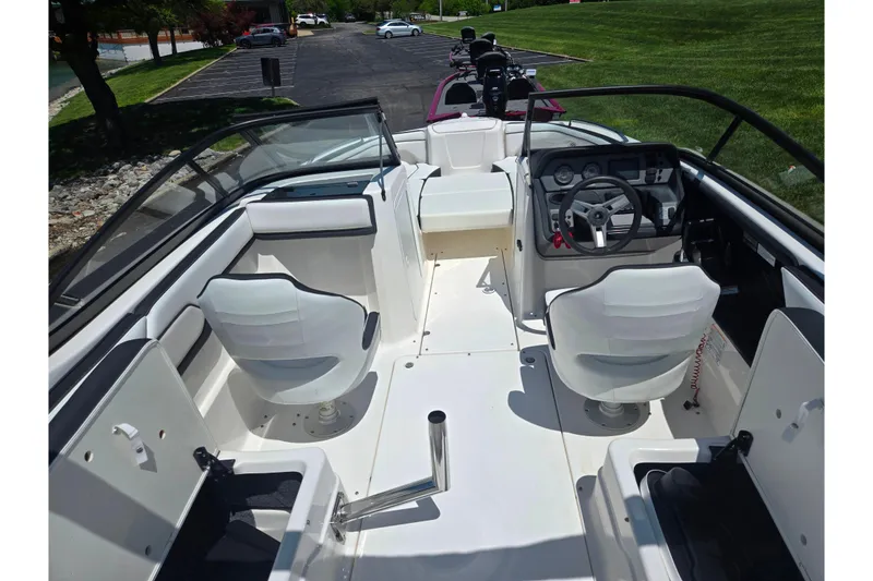 Slide: The Image of 2019 Yamaha Boats SX210 interior with dual white seats and steering console. - 10