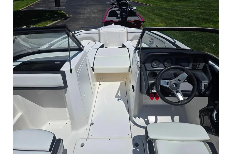 Slide: The Image of 2019 Yamaha Boats SX210 interior with steering wheel and seating, showcasing modern design. - 13