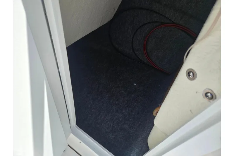 Slide: The Image of Interior view of a 2019 Yamaha SX210 boat storage compartment with visible wiring. - 15