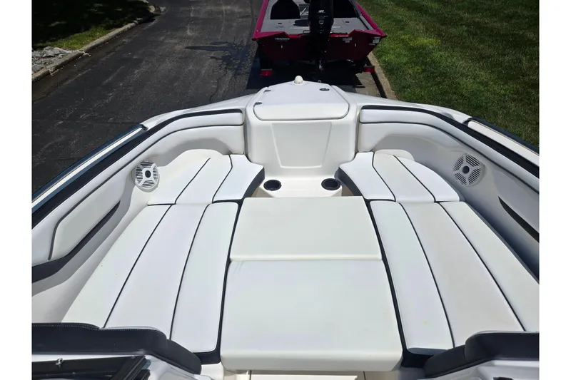 Slide: The Image of 2019 Yamaha Boats SX210 interior with white seating and cup holders. - 17