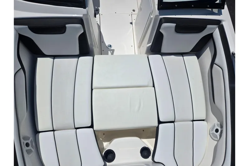 Slide: The Image of 2019 Yamaha Boats SX210 interior seating with white and black upholstery. - 18