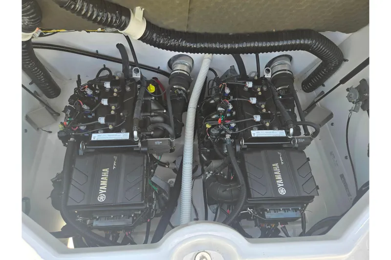 Slide: The Image of 2019 Yamaha Boats SX210 engine compartment with dual engines and wiring. - 22