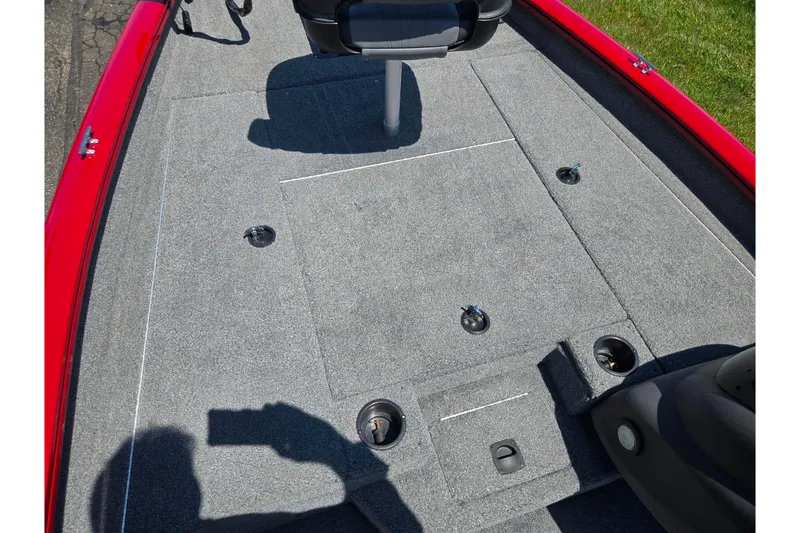 Slide: The Image of 2019 Tracker Pro Team 175 TXW boat interior with gray carpet and seating. - 14