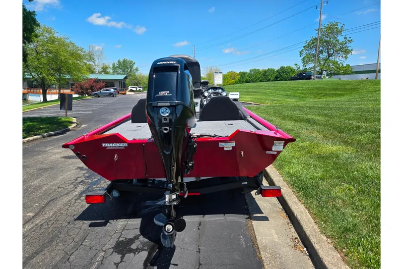 Slide: The Image of 2019 Tracker Pro Team 175 TXW boat with Mercury engine, parked on a sunny day. - 2
