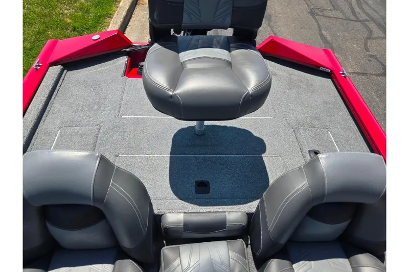 Slide: The Image of 2019 Tracker Pro Team 175 TXW boat interior with gray seating and red accents. - 20