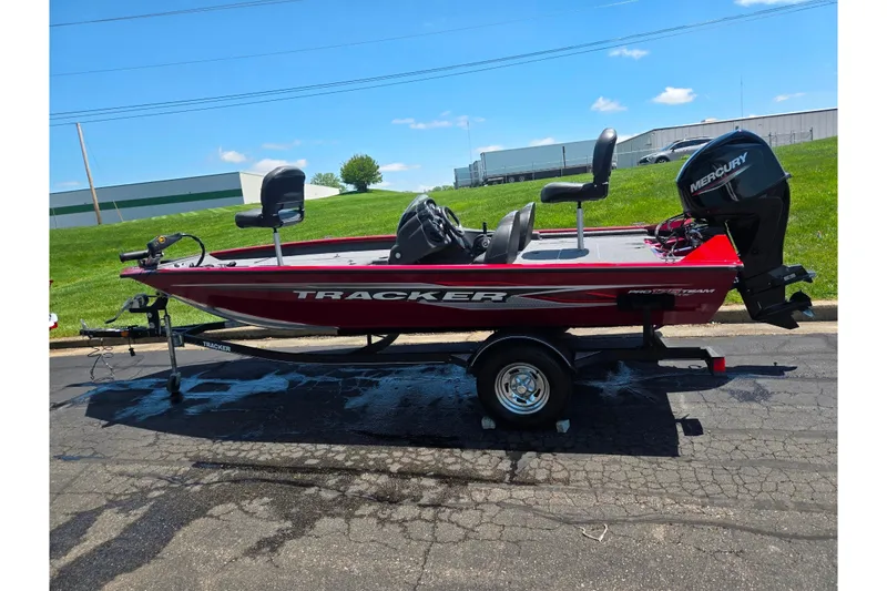 Slide: The Image of 2019 Tracker Pro Team 175 TXW boat on trailer, red exterior, parked outdoors. - 4