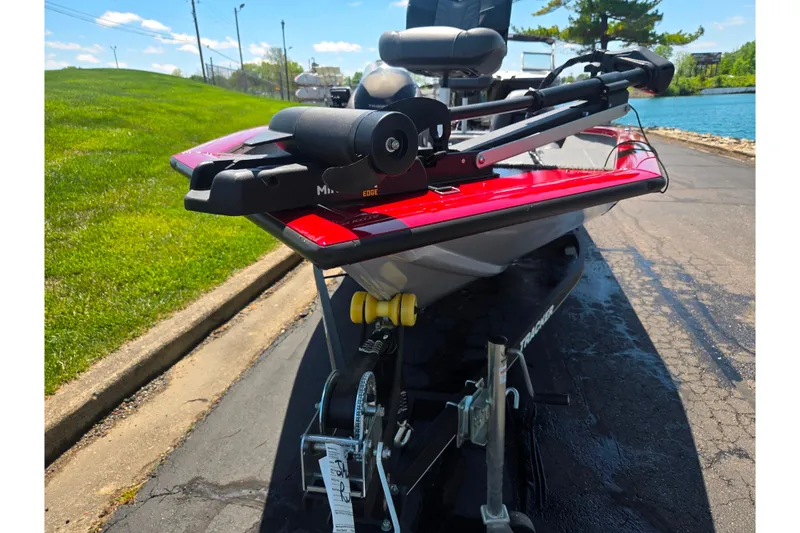 Slide: The Image of 2019 Tracker Pro Team 175 TXW boat on trailer, parked near a lake. - 7