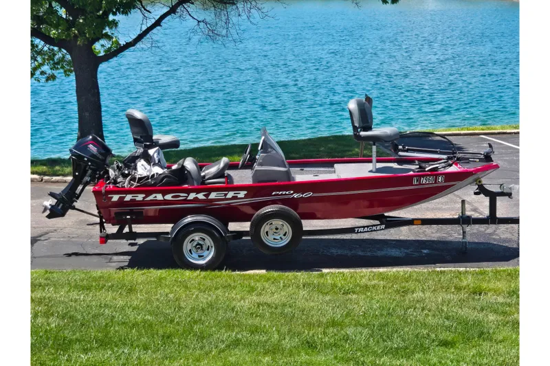 The Image of 2020 Tracker Pro 160 boat on trailer by a lake, under a tree. - 0