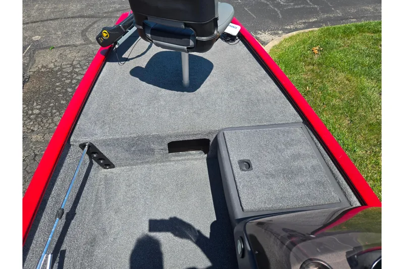 Slide: The Image of 2020 Tracker Pro 160 boat interior with gray carpet and red trim. - 12