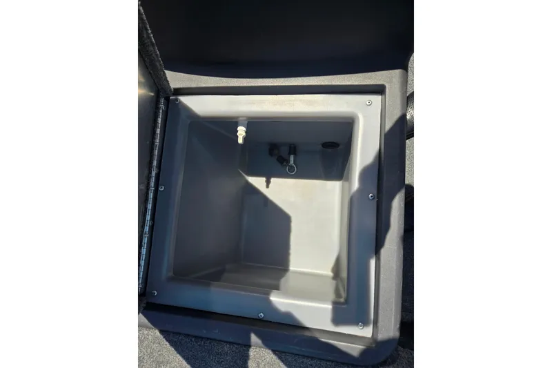 Slide: The Image of 2020 Tracker Pro 160 livewell compartment, open and empty, with visible fittings. - 13