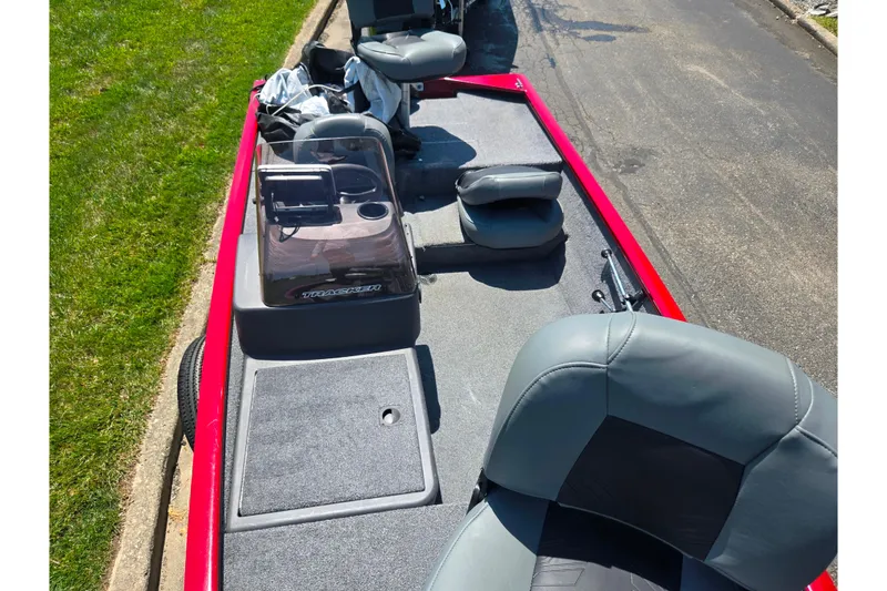 Slide: The Image of 2020 Tracker Pro 160 boat interior with gray seating and red exterior. - 15
