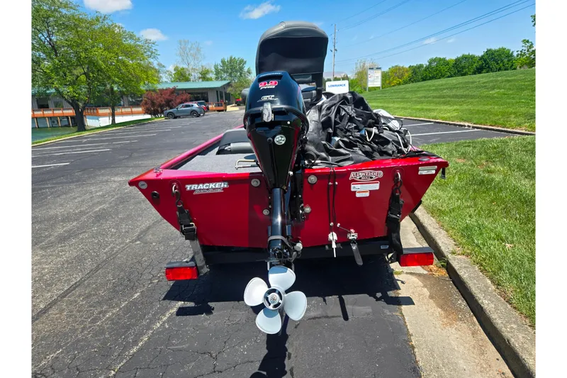 Slide: The Image of 2020 Tracker Pro 160 boat with outboard motor in parking lot. - 2