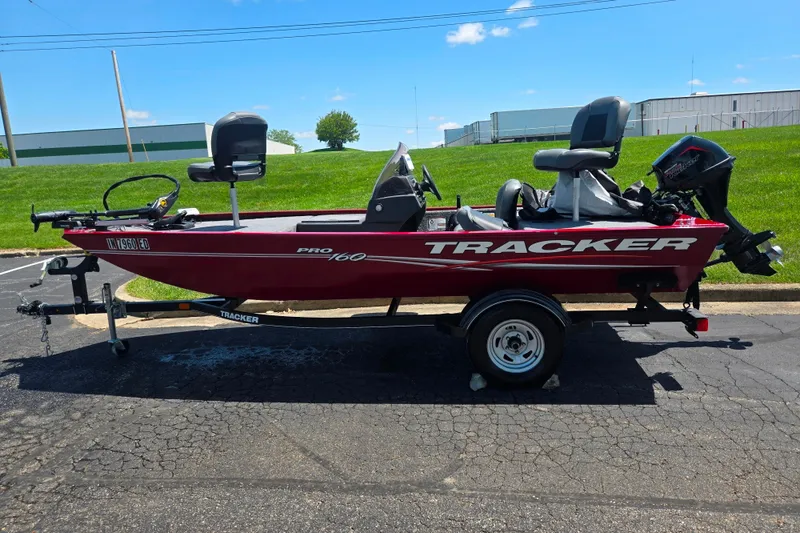 Slide: The Image of 2020 Tracker Pro 160 fishing boat on trailer, parked outdoors on sunny day. - 4