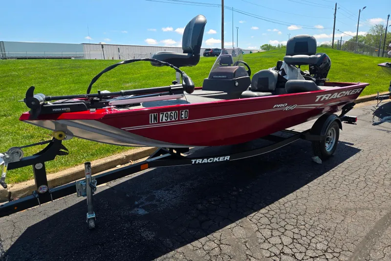 Slide: The Image of 2020 Tracker Pro 160 boat on trailer, red exterior, parked outdoors. - 5
