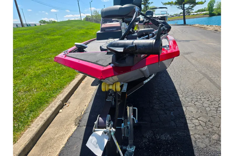 Slide: The Image of 2020 Tracker Pro 160 boat on trailer, parked near a lake on a sunny day. - 6