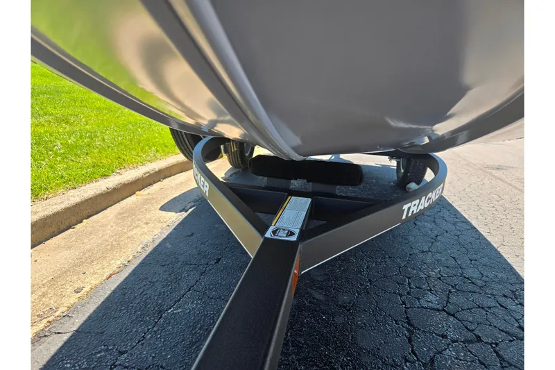 Slide: The Image of 2020 Tracker Pro 160 boat trailer on pavement, close-up view. - 7