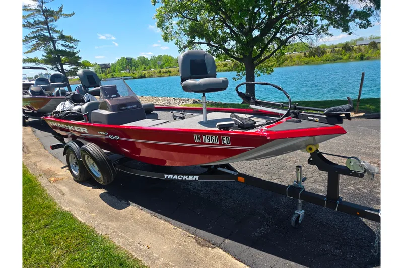 Slide: The Image of 2020 Tracker Pro 160 boat on trailer by a scenic lake. - 8