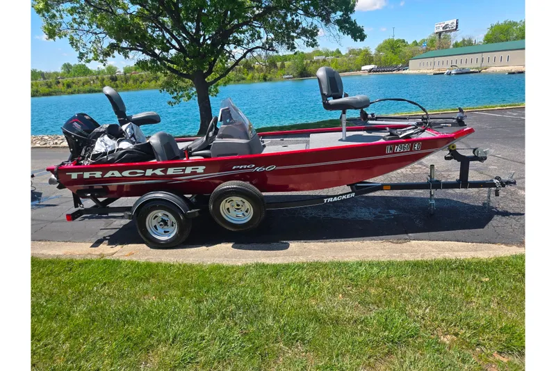 Slide: The Image of 2020 Tracker Pro 160 boat on trailer by a lake, under a tree. - 9