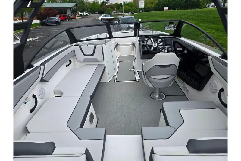 Slide: The Image of 2024 Yamaha Boats AR220 interior with sleek seating and modern dashboard design. - 10