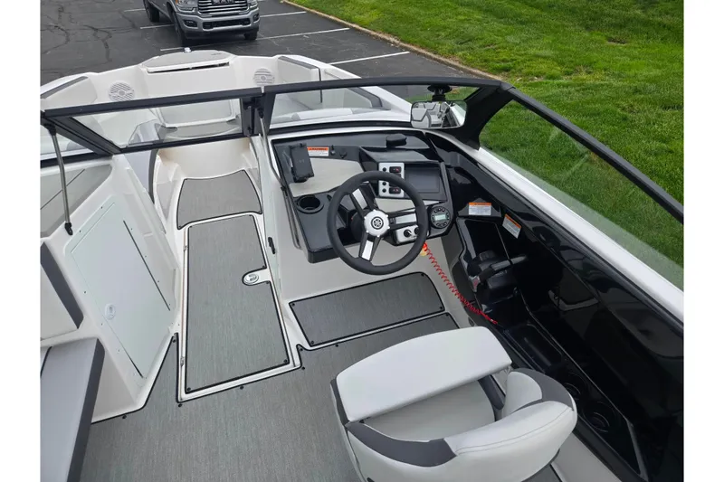 Slide: The Image of 2024 Yamaha Boats AR220 interior with modern dashboard and steering wheel design. - 11