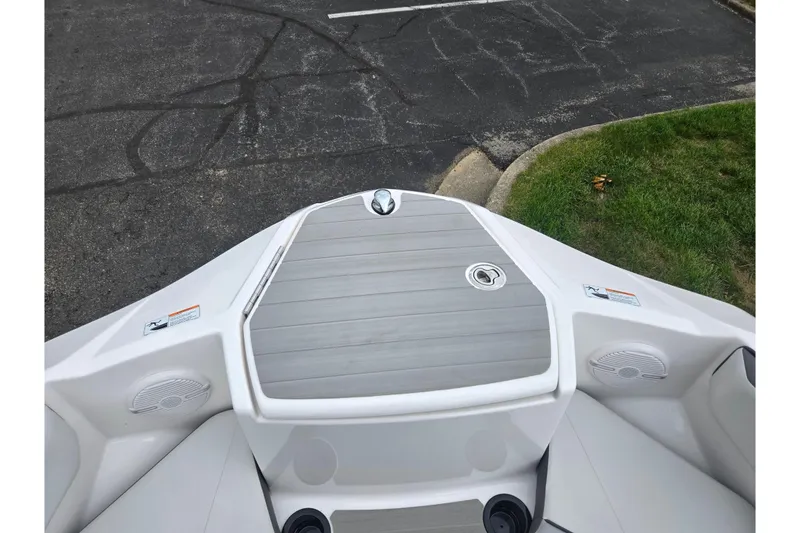 Slide: The Image of 2024 Yamaha Boats AR220 bow area with sleek design and integrated speakers. - 16