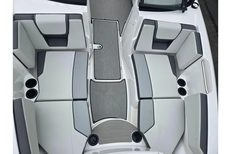Slide: The Image of 2024 Yamaha Boats AR220 interior with gray and white seating and cup holders. - 17
